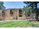 A beautiful manicured green lawn welcomes the condo with inviting patios and red trim at 1060 S Parker Rd # 9, Denver, CO 80231