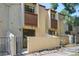 A condo building provides inviting private patios with brick accents and dark red trim at 1060 S Parker Rd # 9, Denver, CO 80231