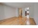 Spacious living room with hardwood floors, white brick accent wall, and open access to kitchen and bathroom at 1060 S Parker Rd # 9, Denver, CO 80231
