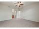 Spacious bedroom featuring a ceiling fan, neutral carpet, and an ensuite bathroom at 9907 Martin Luther King Blvd # 103, Denver, CO 80238