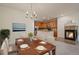 Dining area with view into the kitchen and a cozy fireplace at 9907 Martin Luther King Blvd # 103, Denver, CO 80238