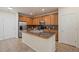 Modern kitchen with stainless steel appliances, granite counters, and tile flooring at 9907 Martin Luther King Blvd # 103, Denver, CO 80238