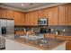 Modern kitchen with stainless steel appliances and granite counters at 9907 Martin Luther King Blvd # 103, Denver, CO 80238