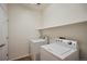 Functional laundry room with a washer, dryer, and shelf for storage solutions at 9907 Martin Luther King Blvd # 103, Denver, CO 80238