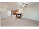 Bright open-concept living room features a fireplace, ceiling fan and neutral tones at 9907 Martin Luther King Blvd # 103, Denver, CO 80238