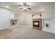 Bright open-concept living room features a fireplace, ceiling fan and neutral tones at 9907 Martin Luther King Blvd # 103, Denver, CO 80238