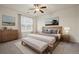 Serene main bedroom with ceiling fan, neutral tones, and lots of natural light at 9907 Martin Luther King Blvd # 103, Denver, CO 80238