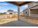 View from covered patio of fenced backyard and neighboring houses on a sunny day at 17831 Parkside N Dr, Commerce City, CO 80022