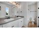 Bright bathroom featuring double sinks, modern lighting, and a separate toilet and shower area at 17831 Parkside N Dr, Commerce City, CO 80022