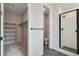 Bathroom featuring a walk-in closet, toilet, and stand-up shower at 17831 Parkside N Dr, Commerce City, CO 80022