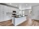 Well-lit kitchen featuring white cabinetry, a dark countertop island, and stainless steel appliances at 17831 Parkside N Dr, Commerce City, CO 80022