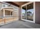 Covered patio area featuring a view of the backyard and adjacent properties with modern exteriors at 17831 Parkside N Dr, Commerce City, CO 80022