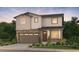 Charming two-story home featuring stone accents, a two-car garage, and manicured landscaping at 2165 S Ider Way, Aurora, CO 80018