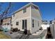 A two-story home showcasing a patio area, lush green lawn, and vinyl siding at 21088 Randolph Pl, Denver, CO 80249