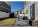 A backyard area with patio space featuring outdoor seating and a grill on a sunny day at 21088 Randolph Pl, Denver, CO 80249