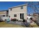 A two-story home showcasing a patio area, lush green lawn, and vinyl siding at 21088 Randolph Pl, Denver, CO 80249