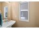 Cozy half bathroom with white fixtures and a window at 21088 Randolph Pl, Denver, CO 80249