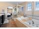 Bathroom with soaking tub, tiled shower and double vanity with dark cabinets at 21088 Randolph Pl, Denver, CO 80249