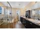 Bathroom featuring a soaking tub, glass shower enclosure, and dual vanities at 21088 Randolph Pl, Denver, CO 80249