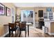 Dining area with a wooden table, chairs, and sliding glass doors to the backyard at 21088 Randolph Pl, Denver, CO 80249