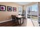 Dining room features a wooden table, black chairs, and access to the backyard at 21088 Randolph Pl, Denver, CO 80249