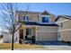 Charming two-story home with an attached garage, manicured lawn, and beautiful curb appeal at 21088 Randolph Pl, Denver, CO 80249