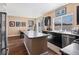 Bright kitchen with a breakfast bar and stainless steel appliances, leading to the dining area at 21088 Randolph Pl, Denver, CO 80249