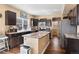 Spacious kitchen with dark cabinets, granite countertops, and a kitchen island at 21088 Randolph Pl, Denver, CO 80249