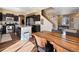 Stylish kitchen featuring dark cabinets, stainless steel appliances, and an island with granite countertops at 21088 Randolph Pl, Denver, CO 80249