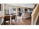 Bright kitchen with an island, dark cabinets, and a dining area with sliding glass doors at 21088 Randolph Pl, Denver, CO 80249