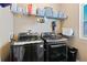 Practical laundry room with a side-by-side washer and dryer and storage shelves at 21088 Randolph Pl, Denver, CO 80249