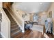 Inviting living room with staircase, a cozy sofa, neutral paint and wood flooring at 21088 Randolph Pl, Denver, CO 80249