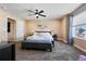 Spacious main bedroom with a ceiling fan, neutral paint, carpet and a large window at 21088 Randolph Pl, Denver, CO 80249