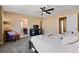 Comfortable main bedroom with a ceiling fan, and archway to an ensuite bathroom at 21088 Randolph Pl, Denver, CO 80249