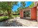 Backyard patio with sliding glass doors leading into the house and mature trees at 1000 Salem St, Aurora, CO 80011