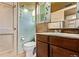 Bathroom featuring a toilet, vanity with sink, and vintage floral wallpaper at 1000 Salem St, Aurora, CO 80011