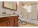 Bathroom with a vanity, toilet, and shower-tub combination with a sliding glass door at 1000 Salem St, Aurora, CO 80011