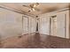 Bedroom with ceiling fan and multiple doors leading to other areas of the home at 1000 Salem St, Aurora, CO 80011
