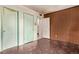 Bedroom with wood paneled walls, two doorways, and a unique floor pattern at 1000 Salem St, Aurora, CO 80011