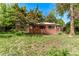 Exterior view of the home with a large front yard and mature trees at 1000 Salem St, Aurora, CO 80011