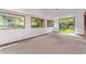 Bright living room with large windows, carpet floors and sliding glass door leading to the backyard at 1000 Salem St, Aurora, CO 80011
