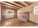 Living room featuring a brick fireplace, built-in shelving and wood floors at 1000 Salem St, Aurora, CO 80011