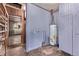 Utility room with water heater, shelving and door leading into another room at 1000 Salem St, Aurora, CO 80011