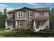 Charming townhome featuring neutral siding, decorative shutters, covered porches, and manicured landscaping at 28640 E 6Th Pl, Watkins, CO 80137