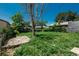 Large backyard with a wooden deck and an overgrown lawn at 10839 Carrol Ln, Northglenn, CO 80233