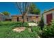 A cozy brick home with a backyard featuring an overgrown garden and a small wooden deck at 10839 Carrol Ln, Northglenn, CO 80233