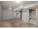 Open basement layout with stairs, utilities access, and carpet flooring throughout at 10839 Carrol Ln, Northglenn, CO 80233