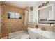 Updated bathroom featuring a shower and tub combination with tiled walls and a modern sink and vanity at 10839 Carrol Ln, Northglenn, CO 80233