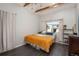Bright bedroom with a window, wood ceiling beams and plank flooring at 10839 Carrol Ln, Northglenn, CO 80233