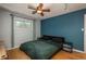 Bedroom featuring a blue accent wall and light colored wood floors at 10839 Carrol Ln, Northglenn, CO 80233